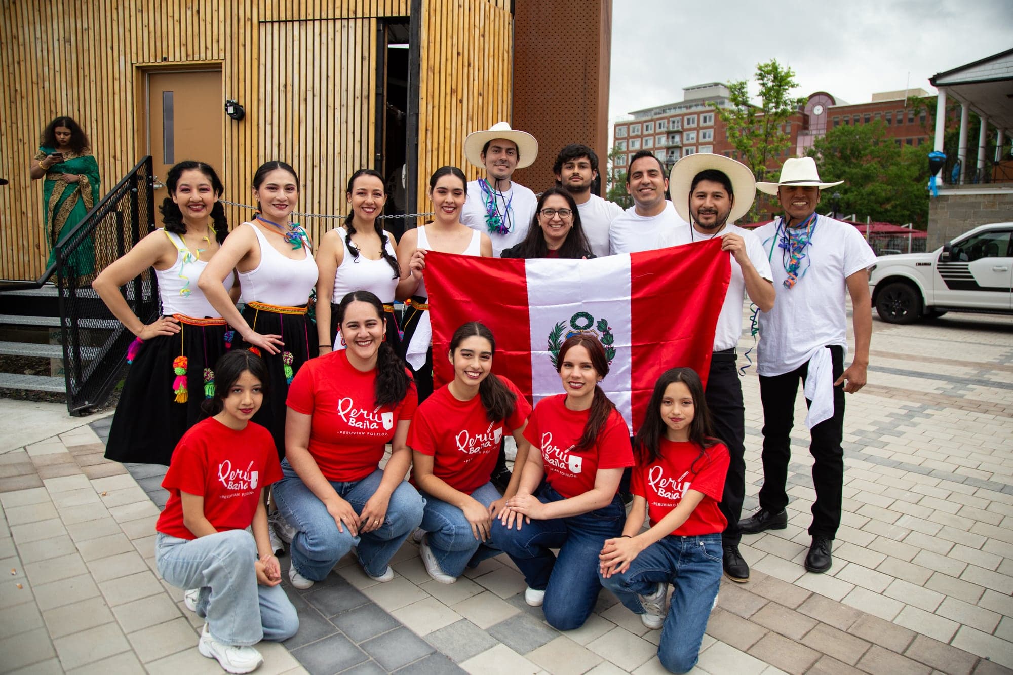 Peru Baila community members gathered with the Peruvian flag
