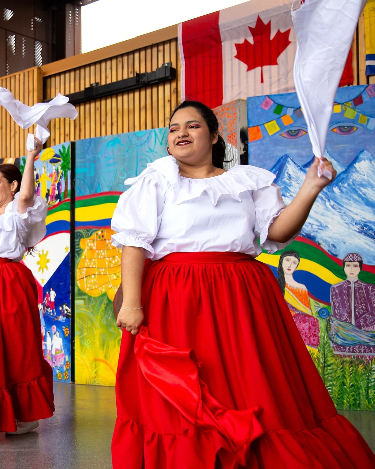 Peru Baila dancer performing Marinera with flowing red skirt and white handkerchiefs